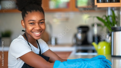 A Smiling Woman Cleaning Kitchen photo