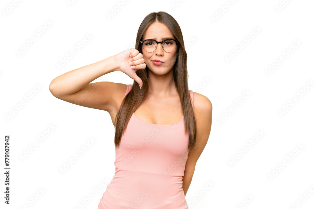 Young pretty caucasian woman over isolated background showing thumb down with negative expression Young pretty caucasian woman over isolated background showing thumb down with negative expression