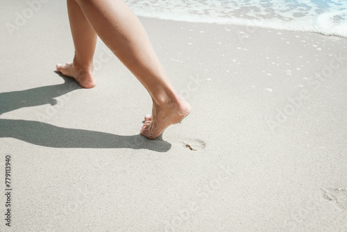 A Feet and footprints by the seashore in nature travel vacation background