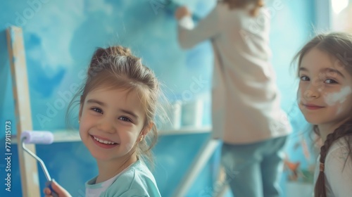 Two girls happily painting a wall with bright smiles