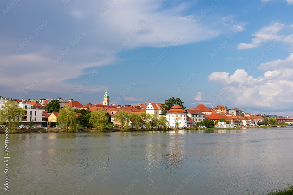 Breathtaking panorama of glistening Drava River as it gracefully winds its way through enchanting city of Maribor, nestled in heart of Slovenia, Europe. Timeless beauty of old town along riverbed