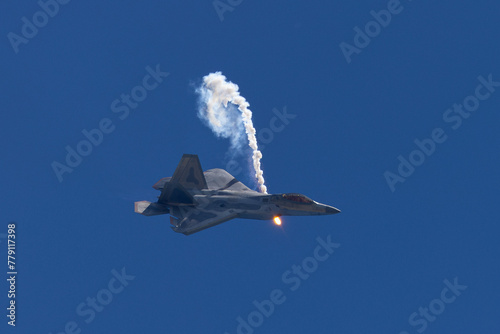 Side view of a F-22 Raptor deploying a flare