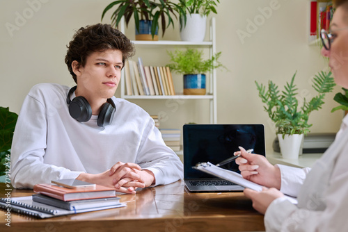 Young male college student at meeting with professional mental therapist