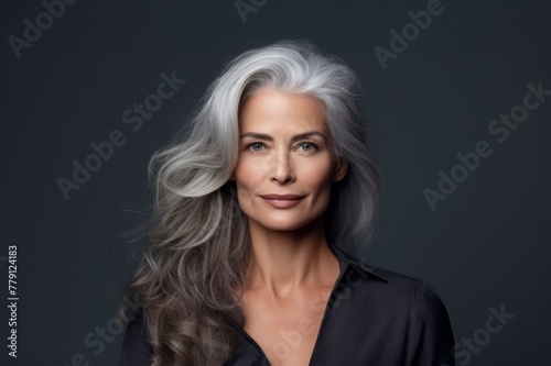 A close-up portrait of an elderly woman with graceful silver hair and a radiant smile.