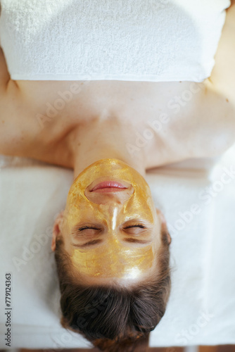 relaxed modern woman in massage cabinet laying on massage table