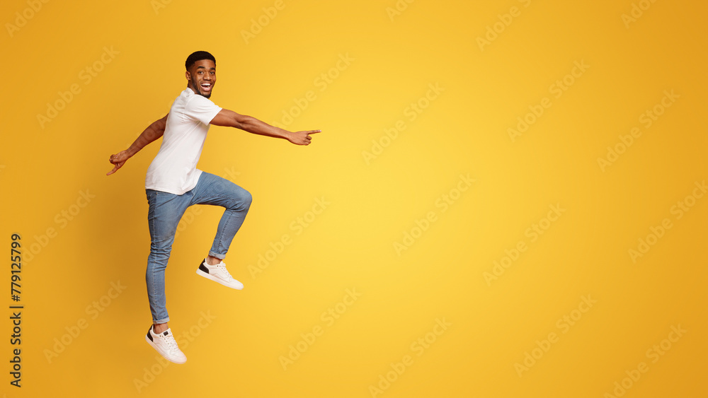 Excited african american guy walking in air