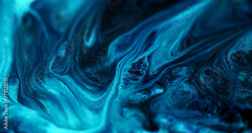 Fototapeta Naklejka Na Ścianę i Meble -  Fluid art. Glitter ink flow. Defocused blue black color shiny dust particles marble texture acrylic paint mix liquid emulsion spill abstract art background.