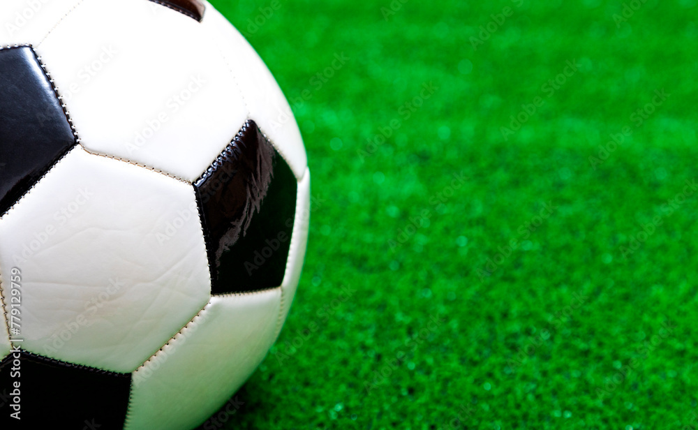Classic soccer ball on artificial green grass - obrazy, fototapety, plakaty 