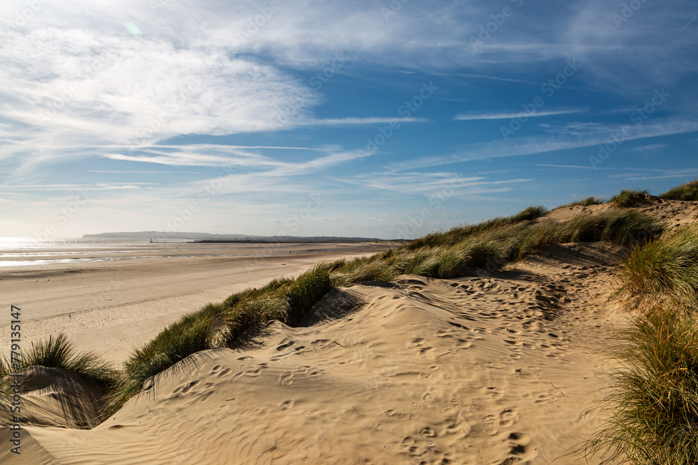 The beach at Camber Sands in Sussex, with a blue sky overhead