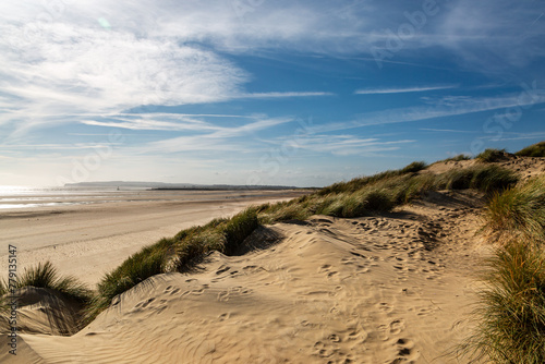 The beach at Camber Sands in Sussex, with a blue sky overhead