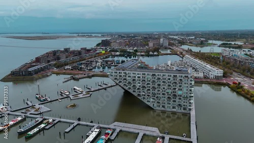 Aerial drone view of Sluishuis modern residential complex on the water Amsterdam Netherlands. High quality 4k footage photo
