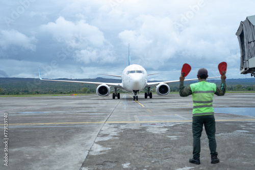 The air marshals directs an aircraft that has just landed