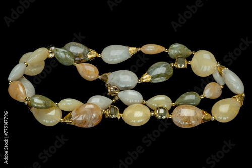 Costume jewellery necklace made up from different gem stones and coupled together with gold clasps and gold coloured pearls.