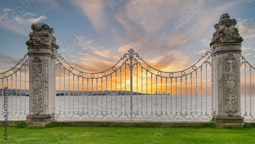 Ornate wrought iron fence decorated with intricate designs at the Dolmabahce Palace overlooking the Bosphorus Strait in Istanbul, Turkey after sunrise