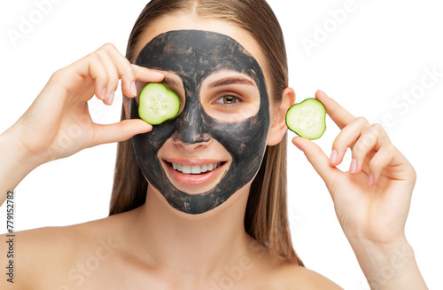 Beautiful smiling woman with clear skin holds a cucumber near her face. She applied the mask to her face. Cosmetological skin care