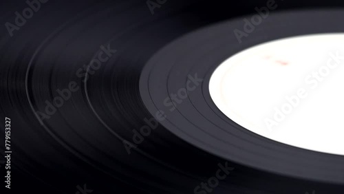 Closeup of a spinning vinyl record. Music playing. Vintage audio nostalgia. photo