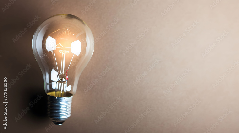 glowing light bulb as a symbol of creativity, ideas and innovation on a dark earthtone gradient background with copyspace for concept text glowing light bulb as a symbol of creativity, ideas and innovation on a dark earthtone gradient background with copyspace for concept text
