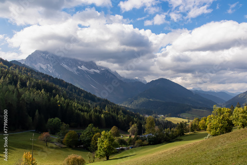 Lush green alpine meadows and forest with scenic view of Karawanks mountain range in Carinthia, Austria. Remote villages on alpine landscape in Bodental, Austrian Alps. Wanderlust concept in spring © Chris