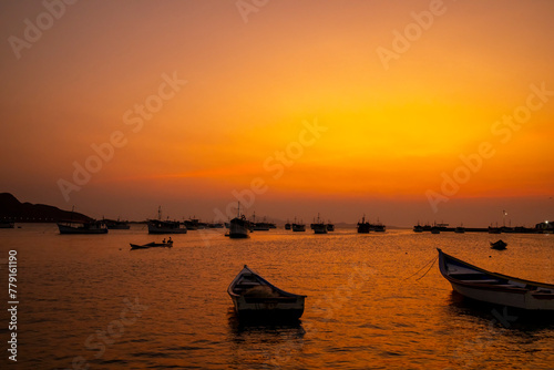 Fishing boats during a beautiful and colorful sunset in Juan Griego beach, Margarita Island. Venezuela