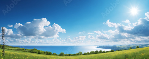 A realistic painting depicting a vast green field with a calm sea in the distance and a blue cloudy sky.