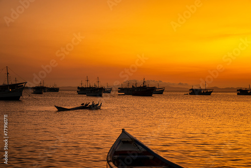 Fishing boats during a beautiful and colorful sunset in Juan Griego beach, Margarita Island. Venezuela photo