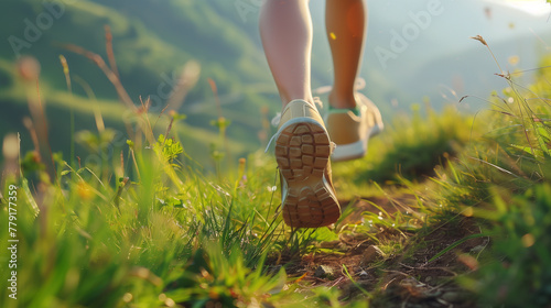 Female legs running and hiking a mountain trial with sport shoes, close up back view portrait
