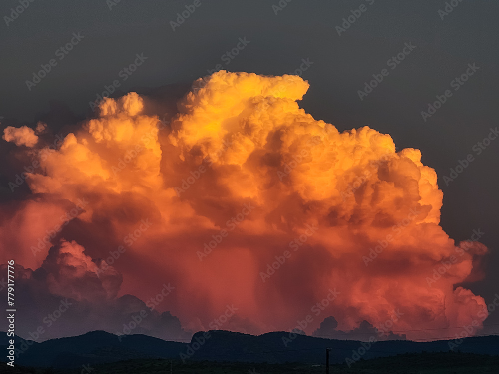 Large Monsoon cloud at sunset: yellow, orange, pink cloud