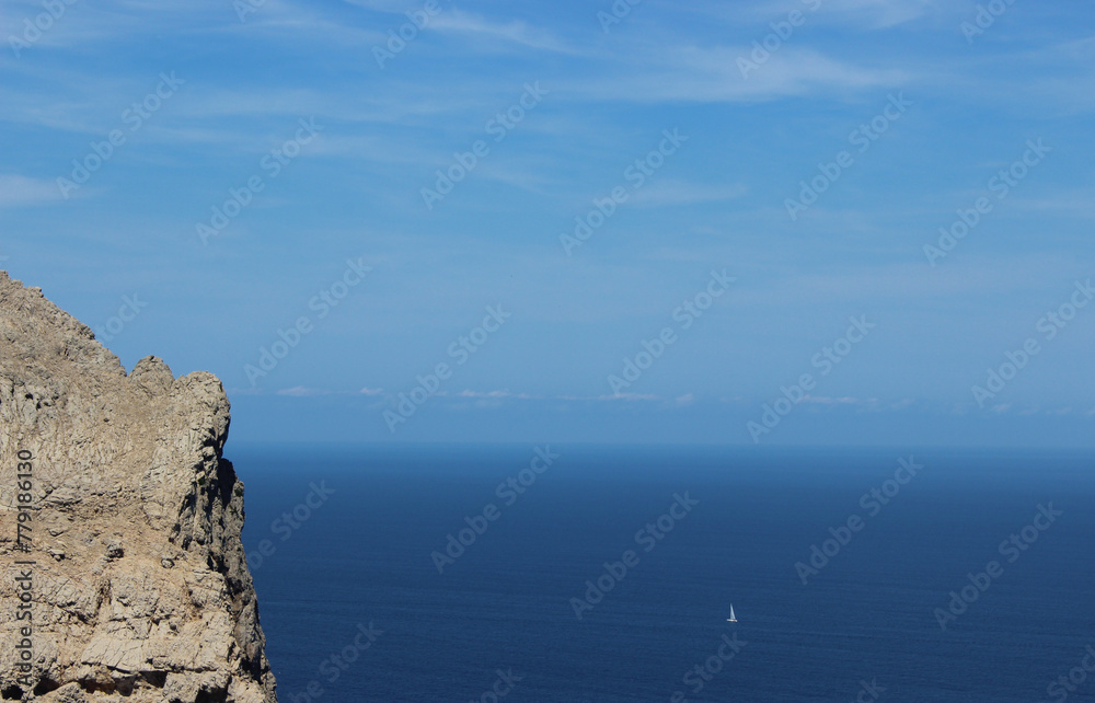 Scenic view of a a small sailboat in the middle of the sea. Located in Cap Formentor, Majorca, Port de Pollenca, Serra de Tramuntana, Balearic Islands, Spain, Europe. 