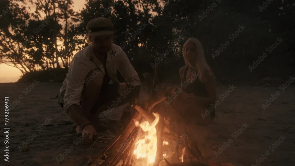 Lovers make a Campfire on the Beach Lovers make a Campfire on the Beach
