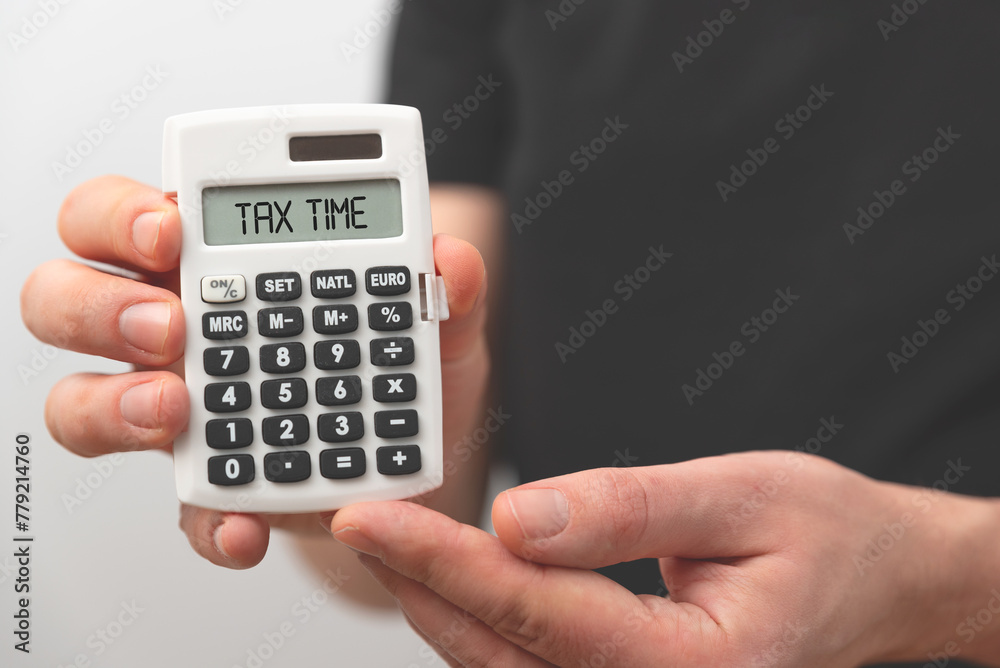 Businessman holding calculator. Tax concept Businessman holding calculator. Tax concept
