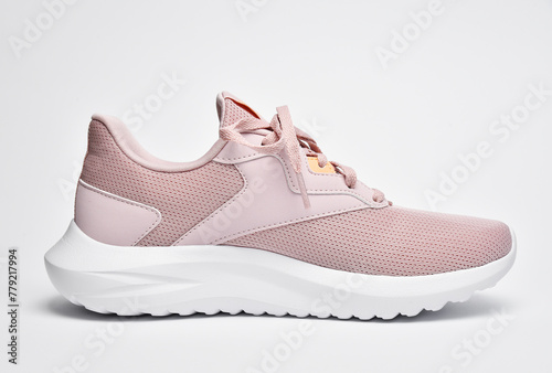 Fototapeta Naklejka Na Ścianę i Meble -  Women's sports shoes beige sneakers side view