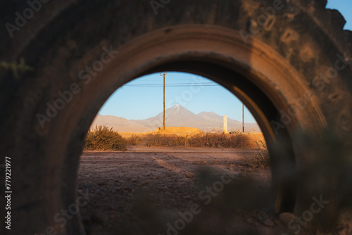 Shot of volcano through a old tire in San Pedro de Atacama  Chile