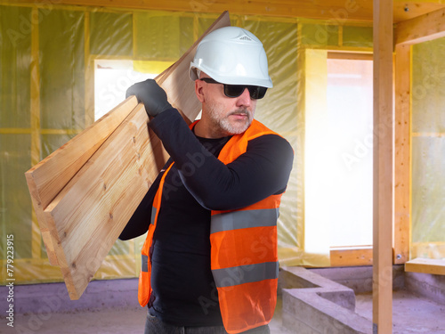 Man builder with boards. Gu...