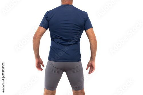 Mature man in sportswear, blue t-shirt and gray shorts, hairy legs, standing and back. Isolated in a white background. Concept of well-being in old age.
