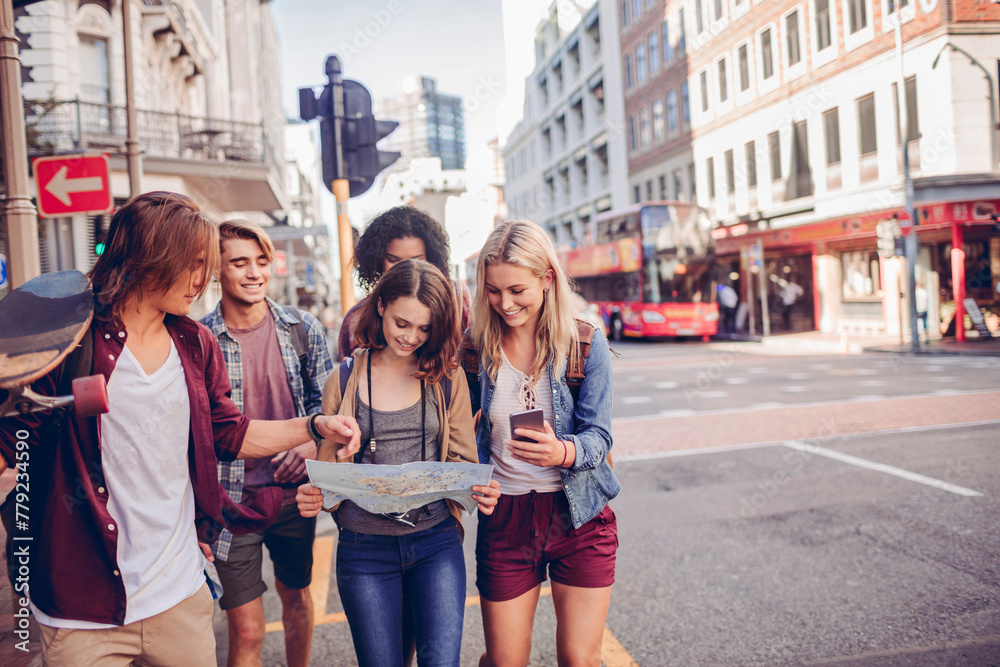 Young tourist people exploring the city with a map Young tourist people exploring the city with a map