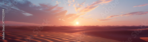 A beautiful sunset over a desert landscape. The sky is filled with clouds and the sun is setting, casting a warm glow over the sand dunes. The scene is serene and peaceful