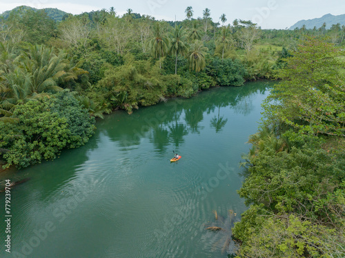 Aerial view of a man paddling alone on a river
