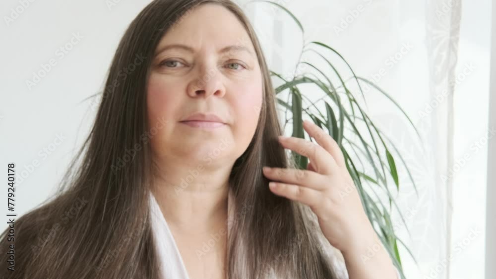 mature brunette woman examines long hair for signs aging, discovering gray hair, checkup, aging problems, concept female age, menopause, midlife crisis, hairloss problem, hormonal imbalance mature brunette woman examines long hair for signs aging, discovering gray hair, checkup, aging problems, concept female age, menopause, midlife crisis, hairloss problem, hormonal imbalance