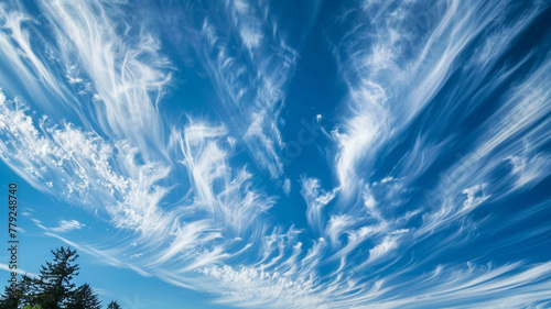 The ethereal beauty of wispy cirrus clouds streaking across a clear, blue sky.