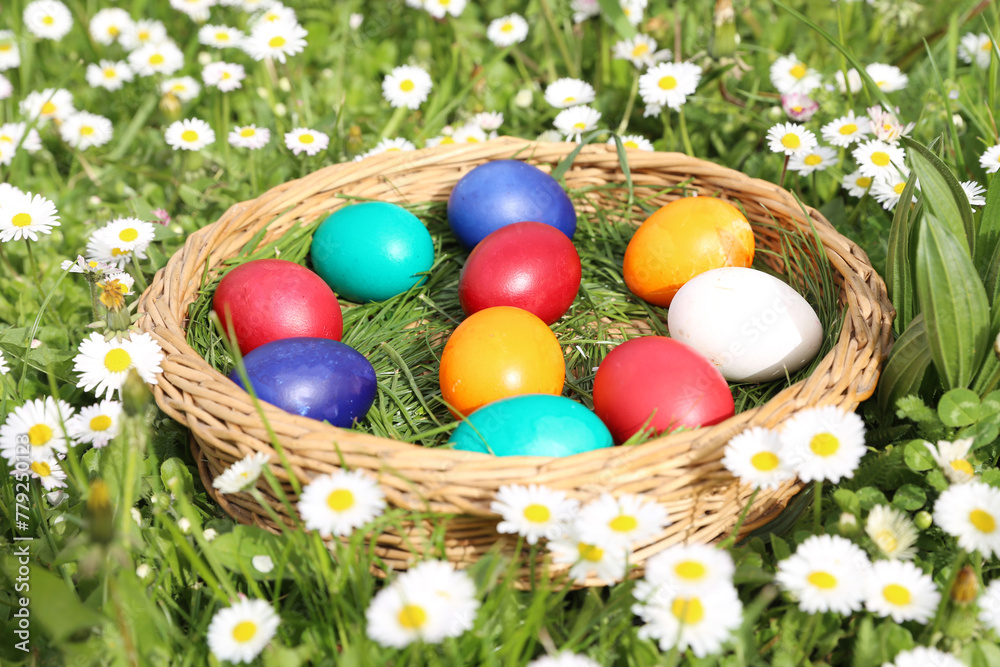 Closeup of colorful eggs in beautiful spring meadow on easter holiday outdoors in green graas.Traditional symbol for christian and catholic holiday