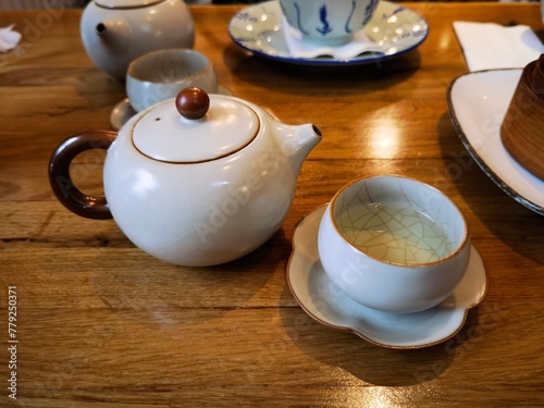 teapot and cups filled with green tea