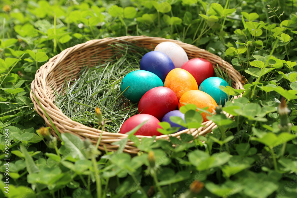 Closeup of colorful eggs in beautiful spring meadow on easter holiday outdoors in green graas.Traditional symbol for christian and catholic holiday Closeup of colorful eggs in beautiful spring meadow on easter holiday outdoors in green graas.Traditional symbol for christian and catholic holiday