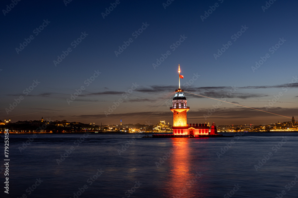 iery sunset over Bosphorus with famous Maiden's Tower (Kiz Kulesi) also known as Leander's Tower, symbol of Istanbul, Turkey. Scenic travel background for wallpaper or guide book