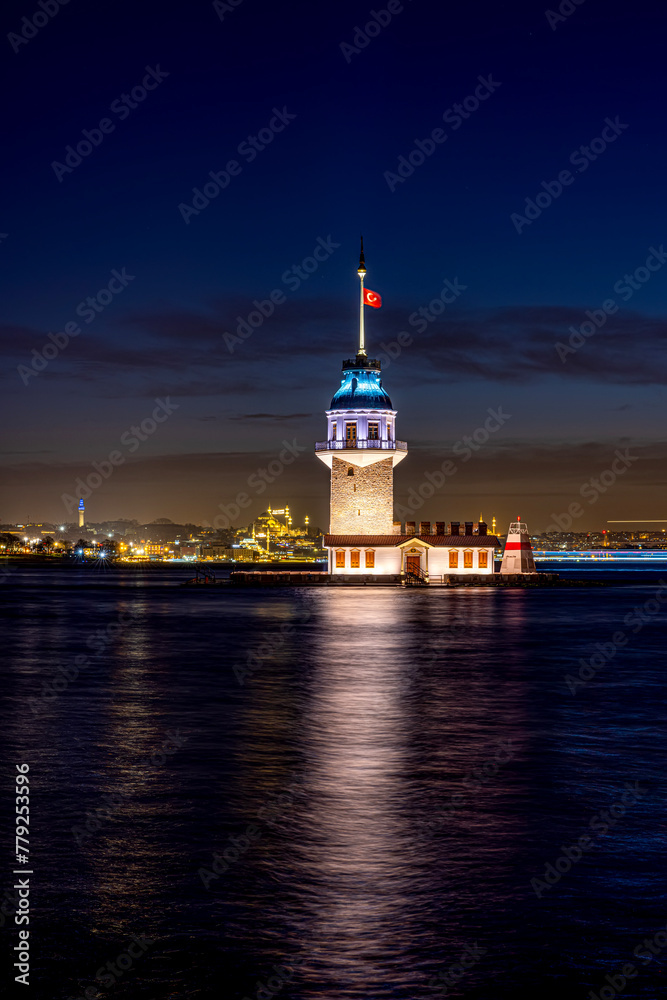 iery sunset over Bosphorus with famous Maiden's Tower (Kiz Kulesi) also known as Leander's Tower, symbol of Istanbul, Turkey. Scenic travel background for wallpaper or guide book