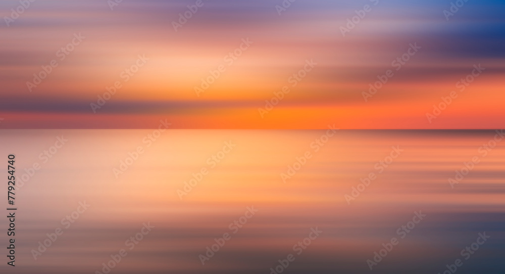 Abstract sun is setting over the ocean, casting warm glow on water. The sky is filled with clouds, creating a moody atmosphere. reflection of sun on water is a beautiful sight to behold, motion blur.