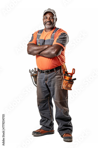 A male service master repairman plumber electrician stands at full height in protective work clothing with his arms crossed. He smiles and holds a toolbox. Isolated on white background