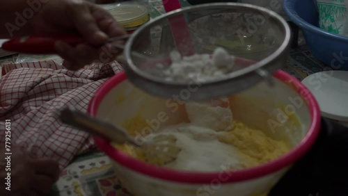 Semprit cake dough consisting of butter, margarine and sugar is being prepared in a plastic container. photo