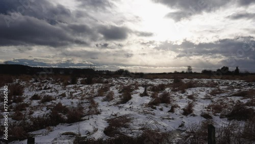 Winter Landscape with Snowy Field and Dramatic Clouded Sky