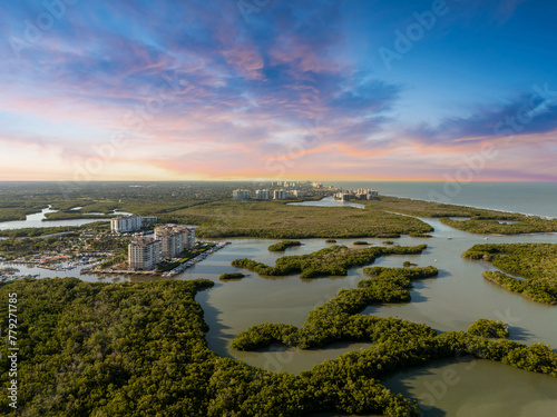 Sunset over mangrove waterway just beyond the ocean