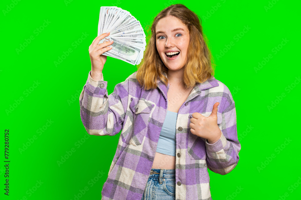 Rich pleased happy caucasian woman waving money dollar cash banknotes bills like a fan, success business career, lottery winner, big income wealth. Redhead girl isolated on green chroma key background Rich pleased happy caucasian woman waving money dollar cash banknotes bills like a fan, success business career, lottery winner, big income wealth. Redhead girl isolated on green chroma key background